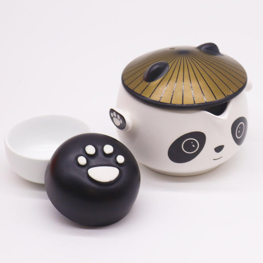 Ceramic panda-shaped teapot with lid and paw-shaped handle on a white background