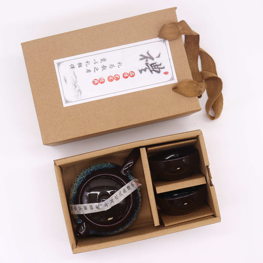 Gift set with two black ceramic bowls in a brown box on a white background