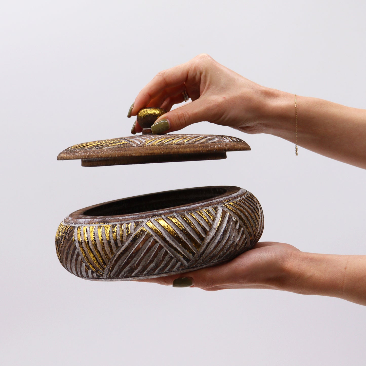 Wooden jar open, displaying carved details and golden finish