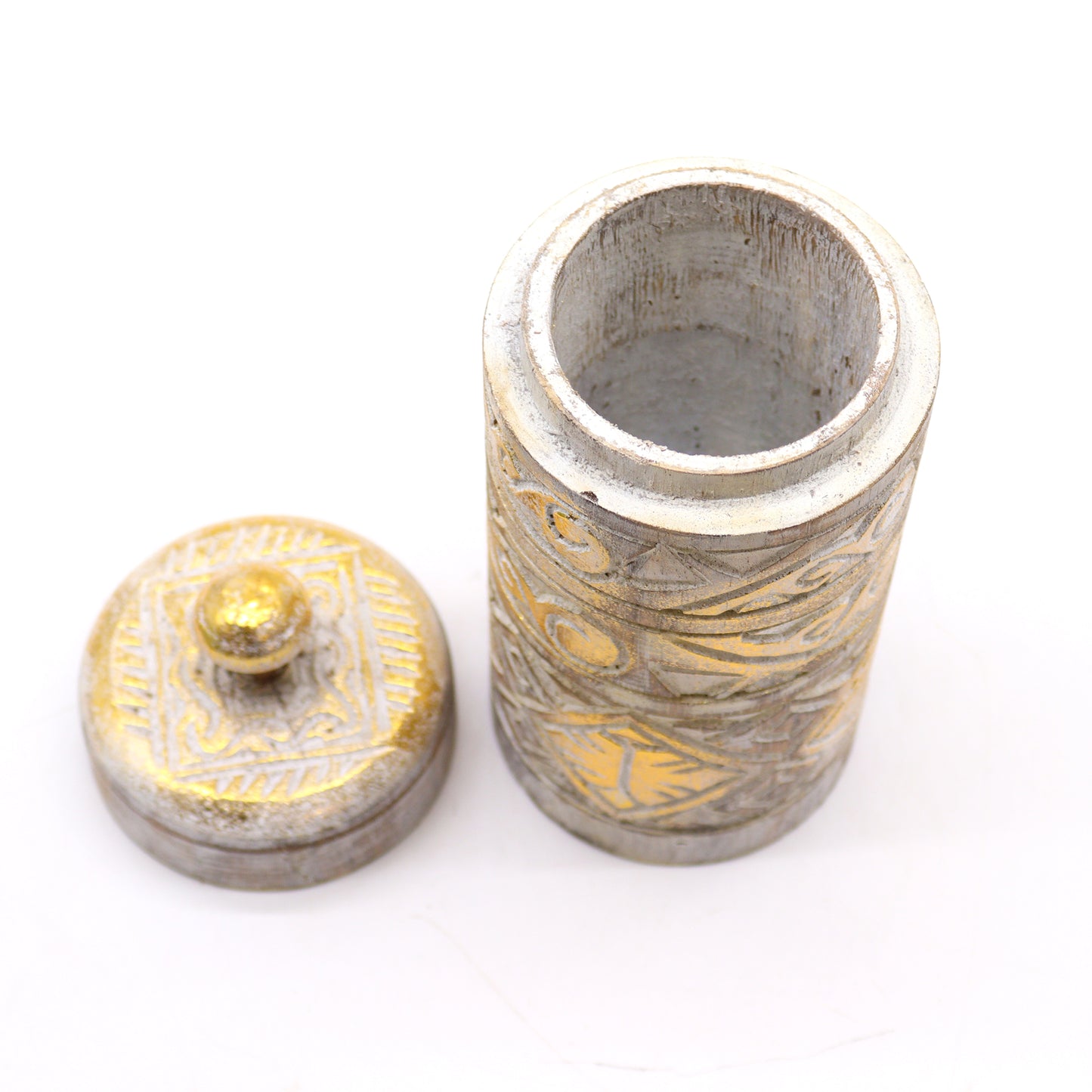 Close-up of hand-carved lid with gold embellishments and open Jar
