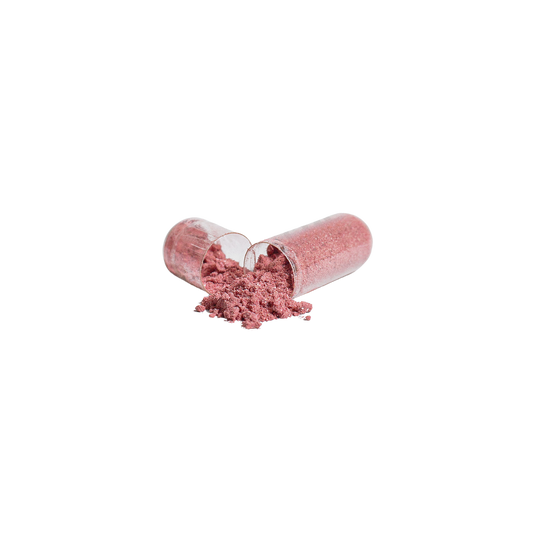 Open beetroot capsule with fine red powder spilling out