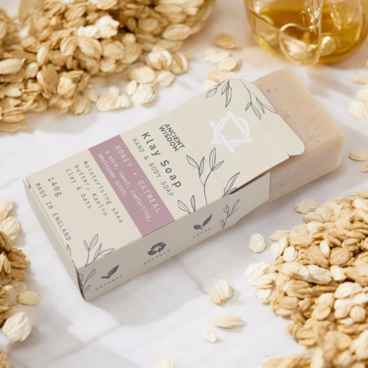 Honey Oatmeal clay soap bar on soft linen with oat flakes