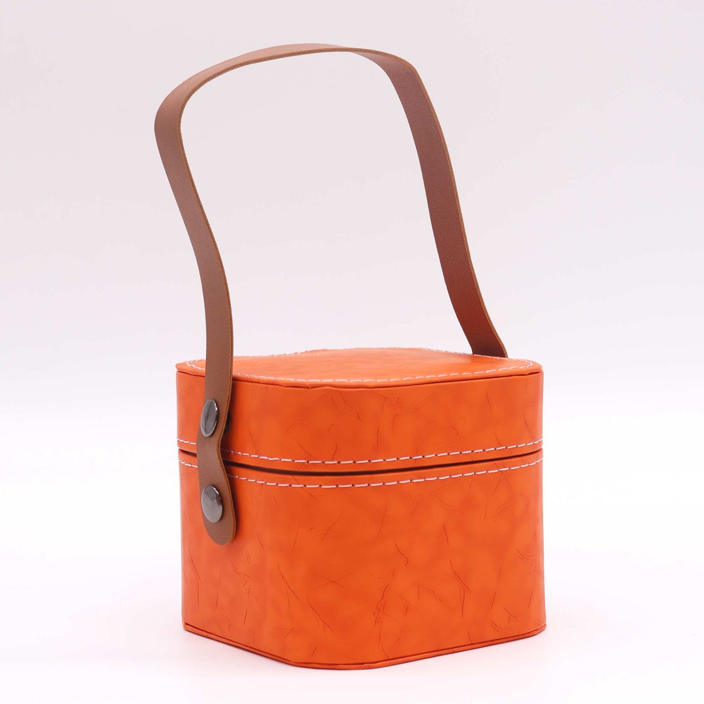 Orange fabric basket with a brown leather handle on a white background