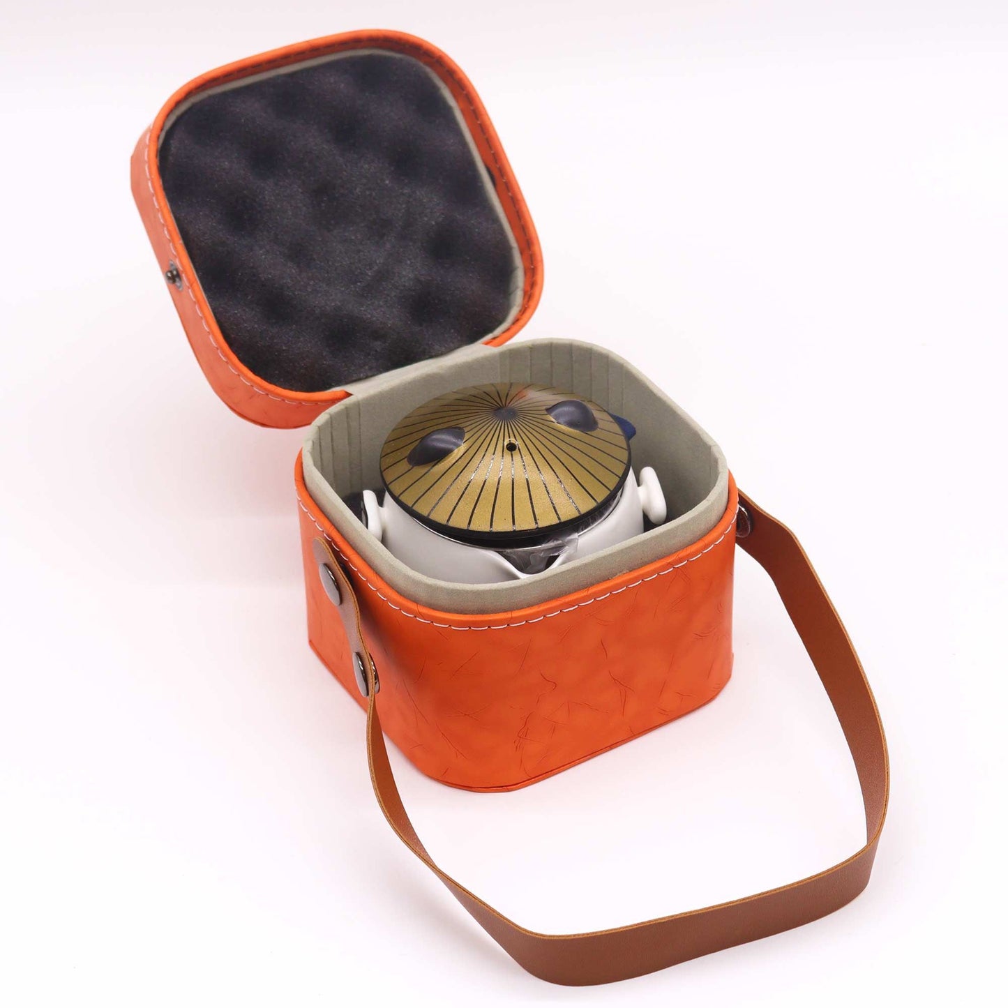 Orange carrying case with a black interior, containing a gold and black object on a white background