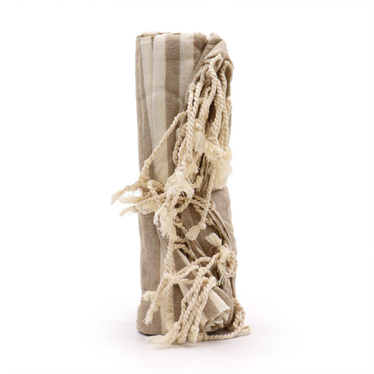 Rolled warm-sand cotton throw included in the Rainy Window Ritual