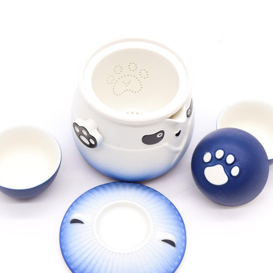 Ceramic cat-shaped bowl with gradient blue and white design, featuring paw prints on a white background.