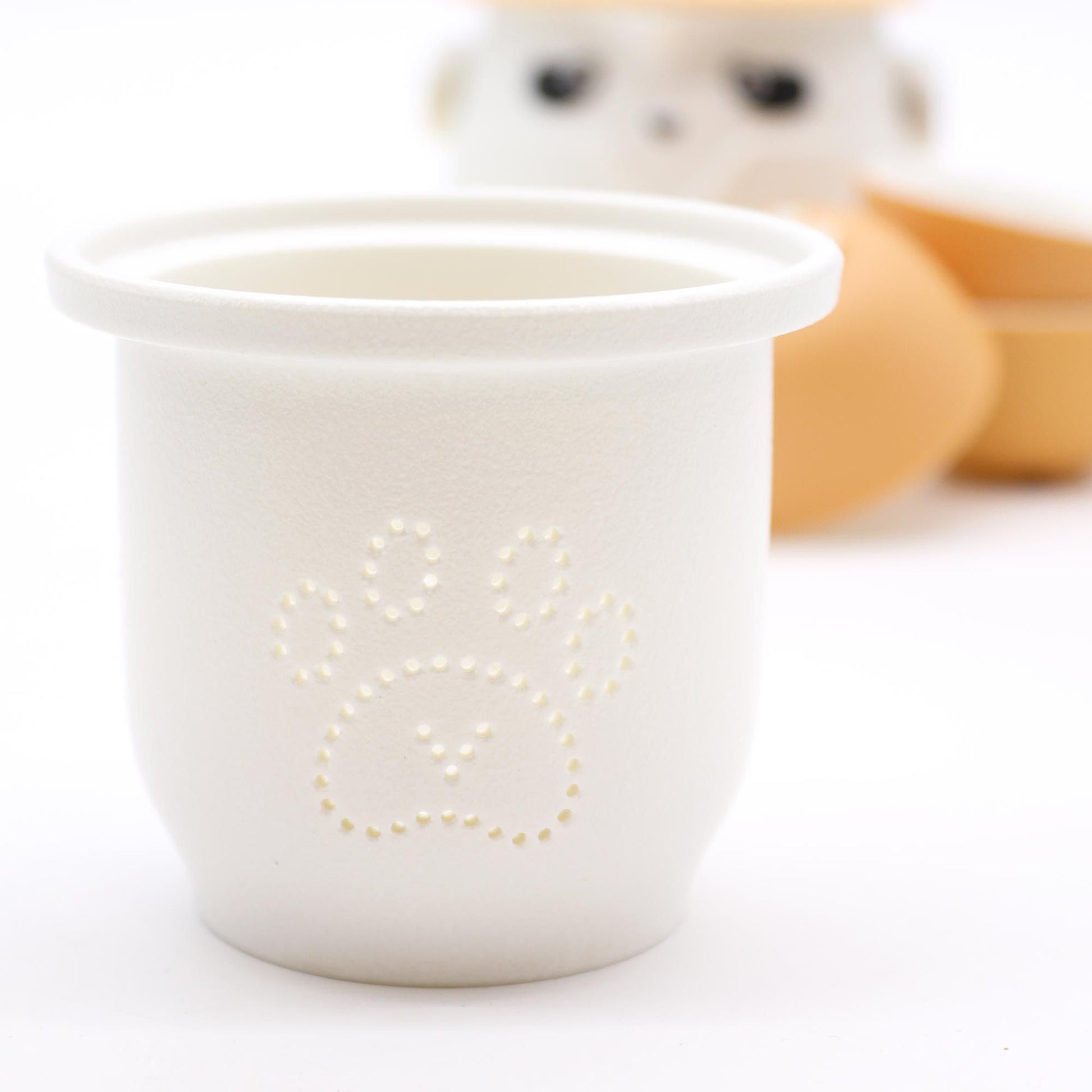 White ceramic cup with star design on a white background
