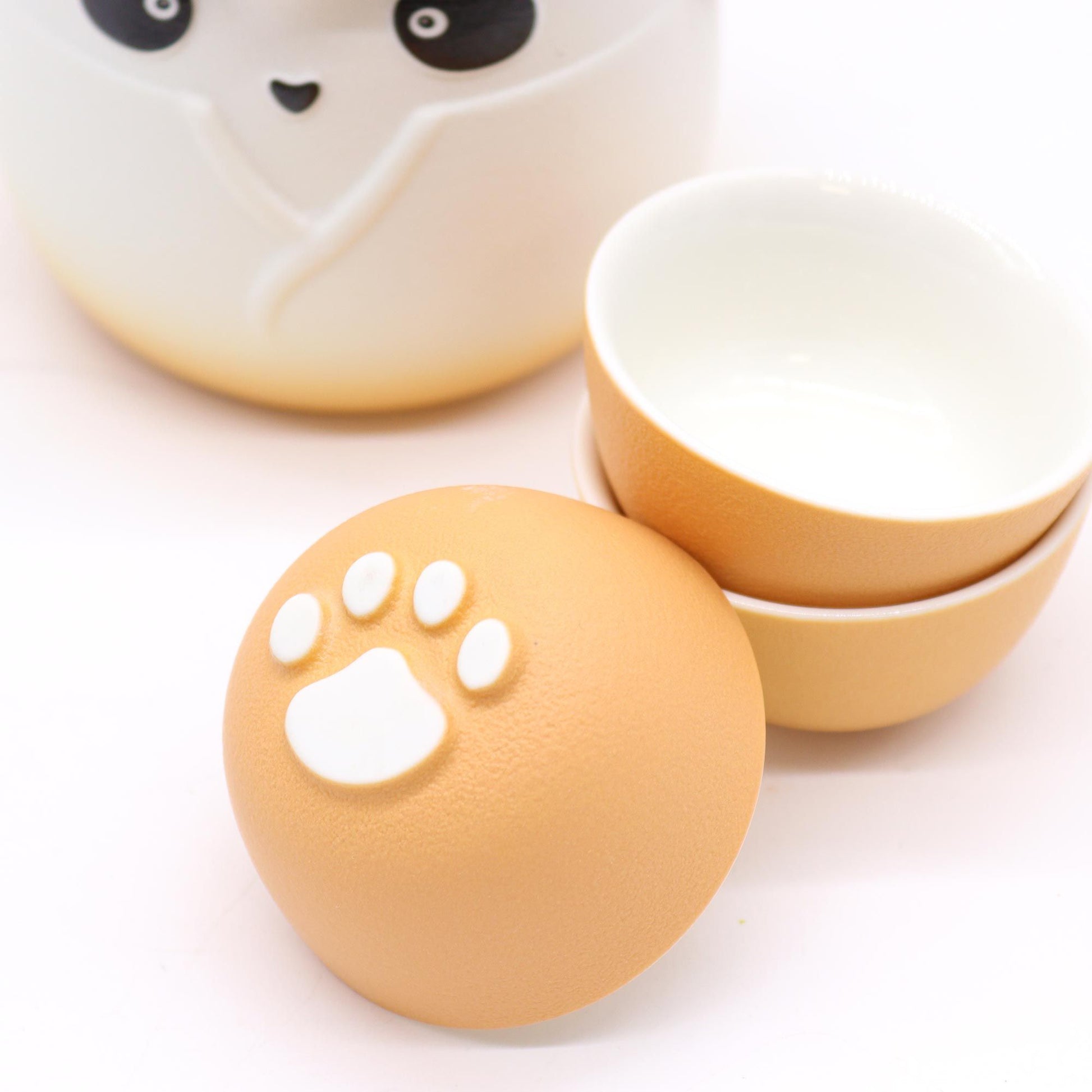 Set of ceramic bowls with paw print design on a white background