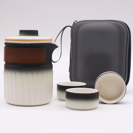 Ceramic tea set with a carrying case on a white background